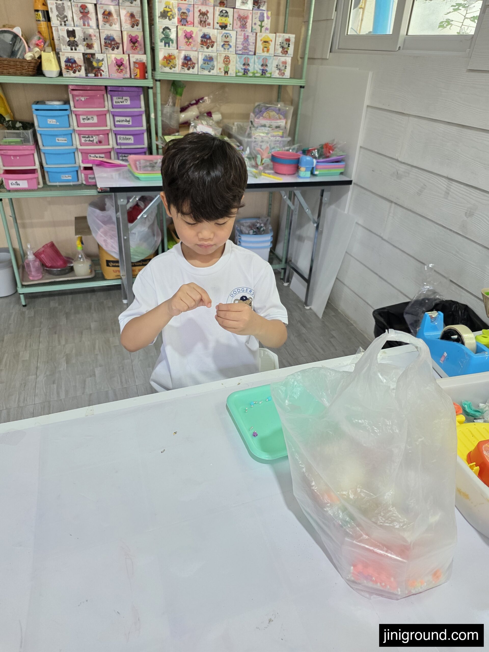 boy focused on craft activity at ABK Art Studio classroom in Chiang Mai Thailand