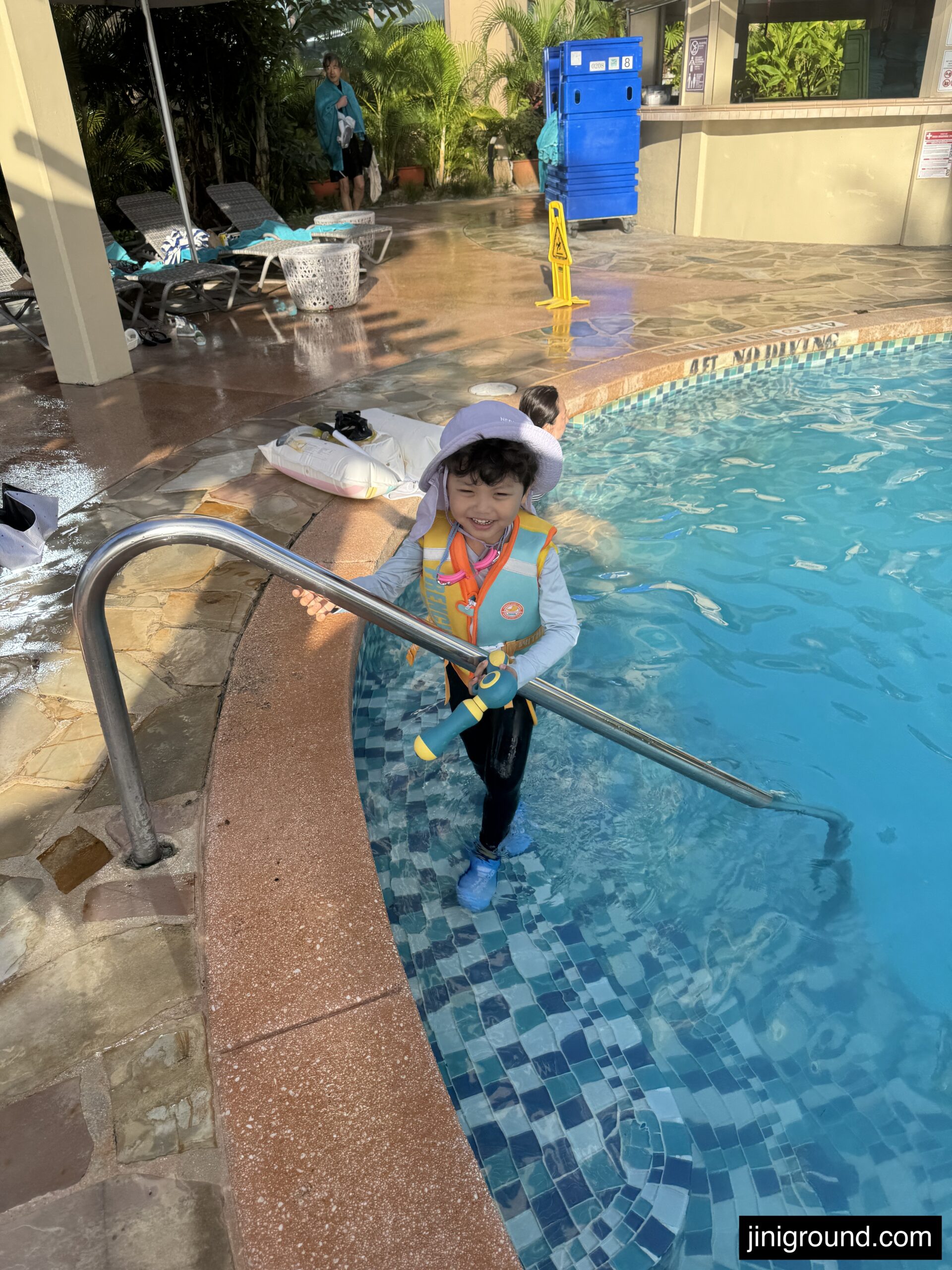 61 month old boy entering large resort swimming pool at Dusit Beach Resort Guam