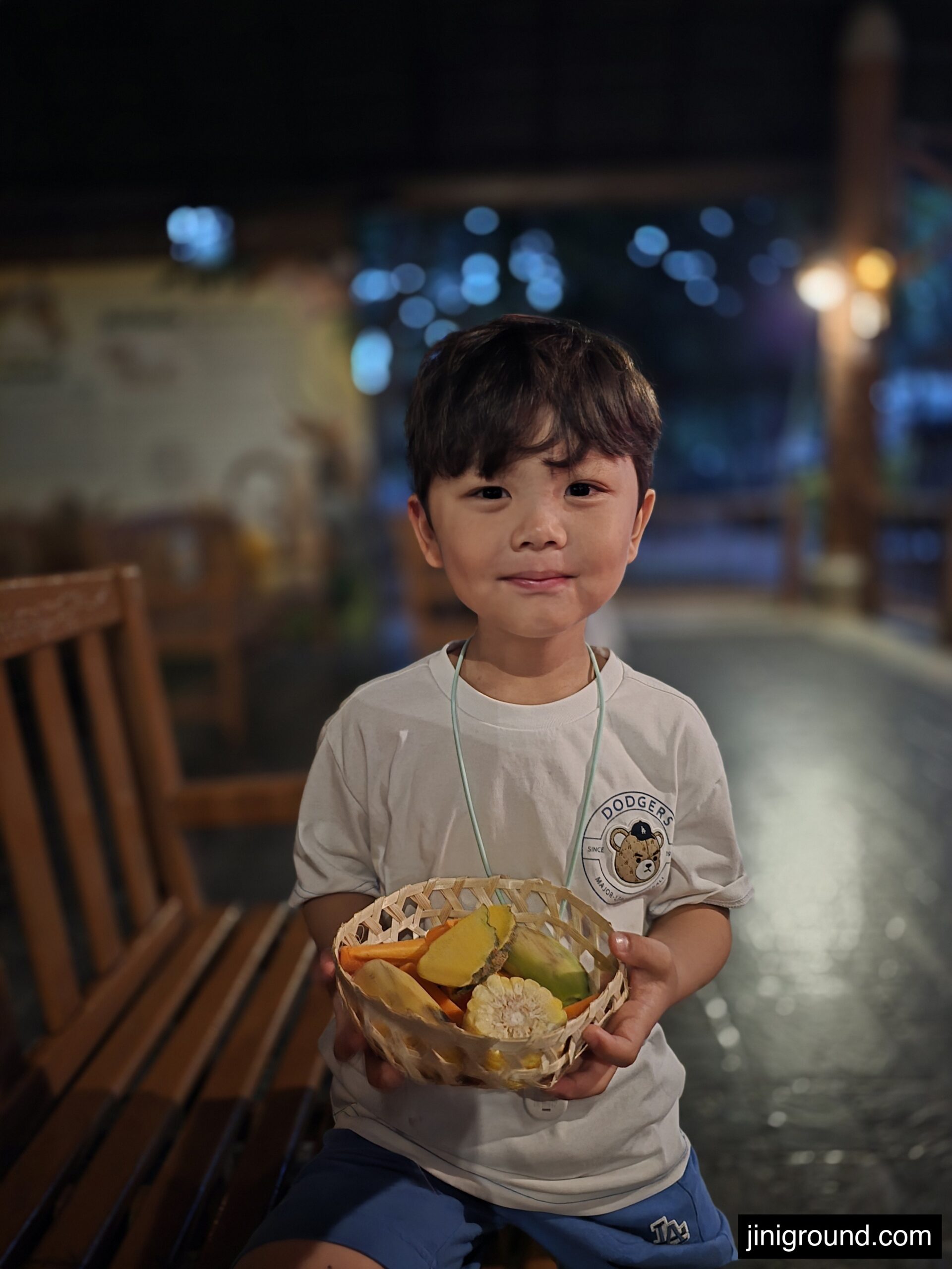 boy holding animal feed basket at Chiang Mai Night Safari entrance Thailand