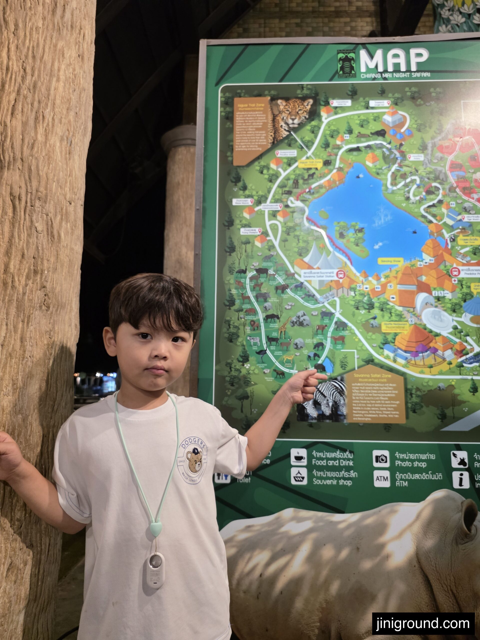 boy pointing at Chiang Mai Night Safari map board at entrance