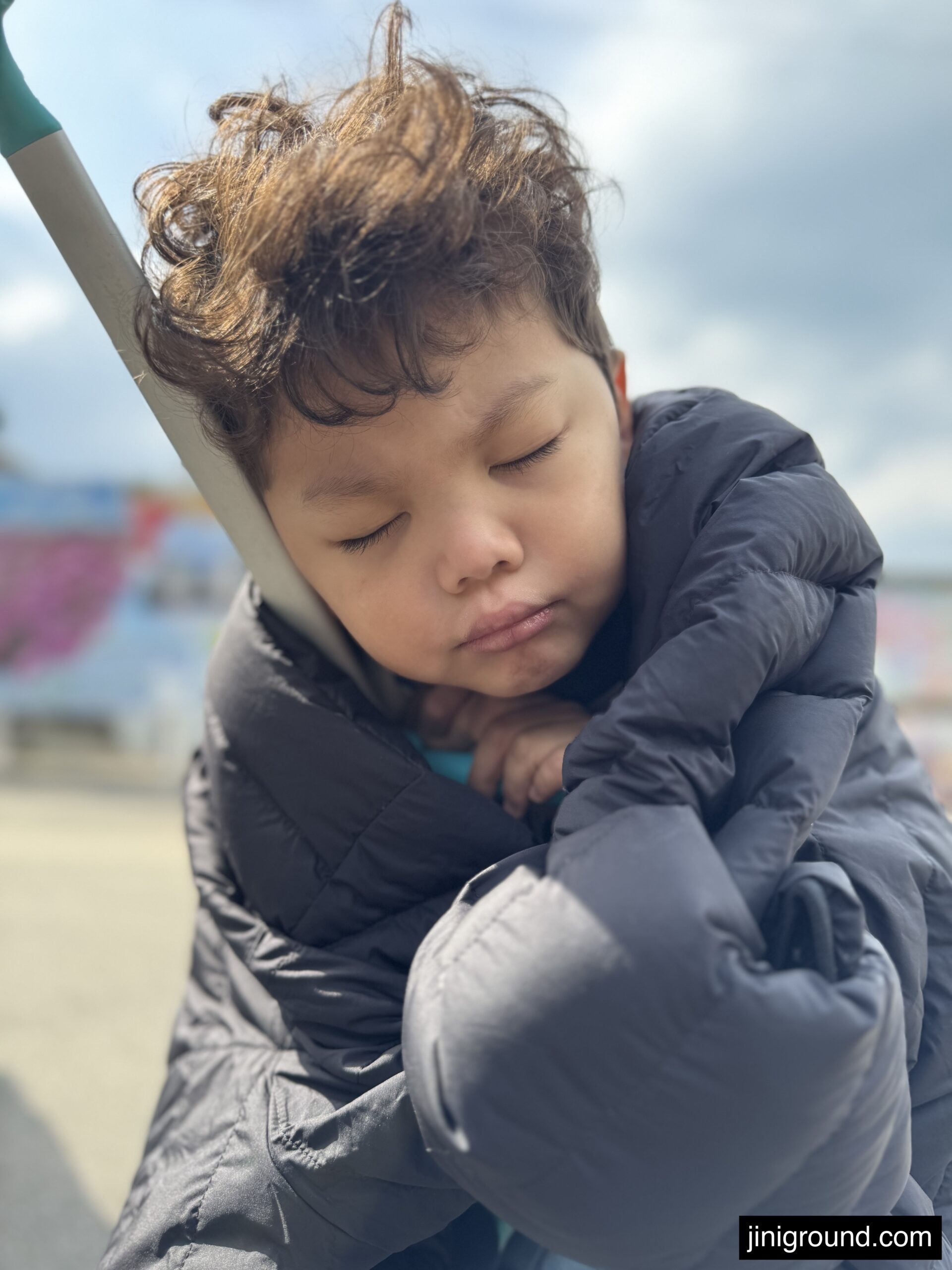 Exhausted 60 month old boy sleeping on dads back after full day at Uminonakamichi Park Fukuoka