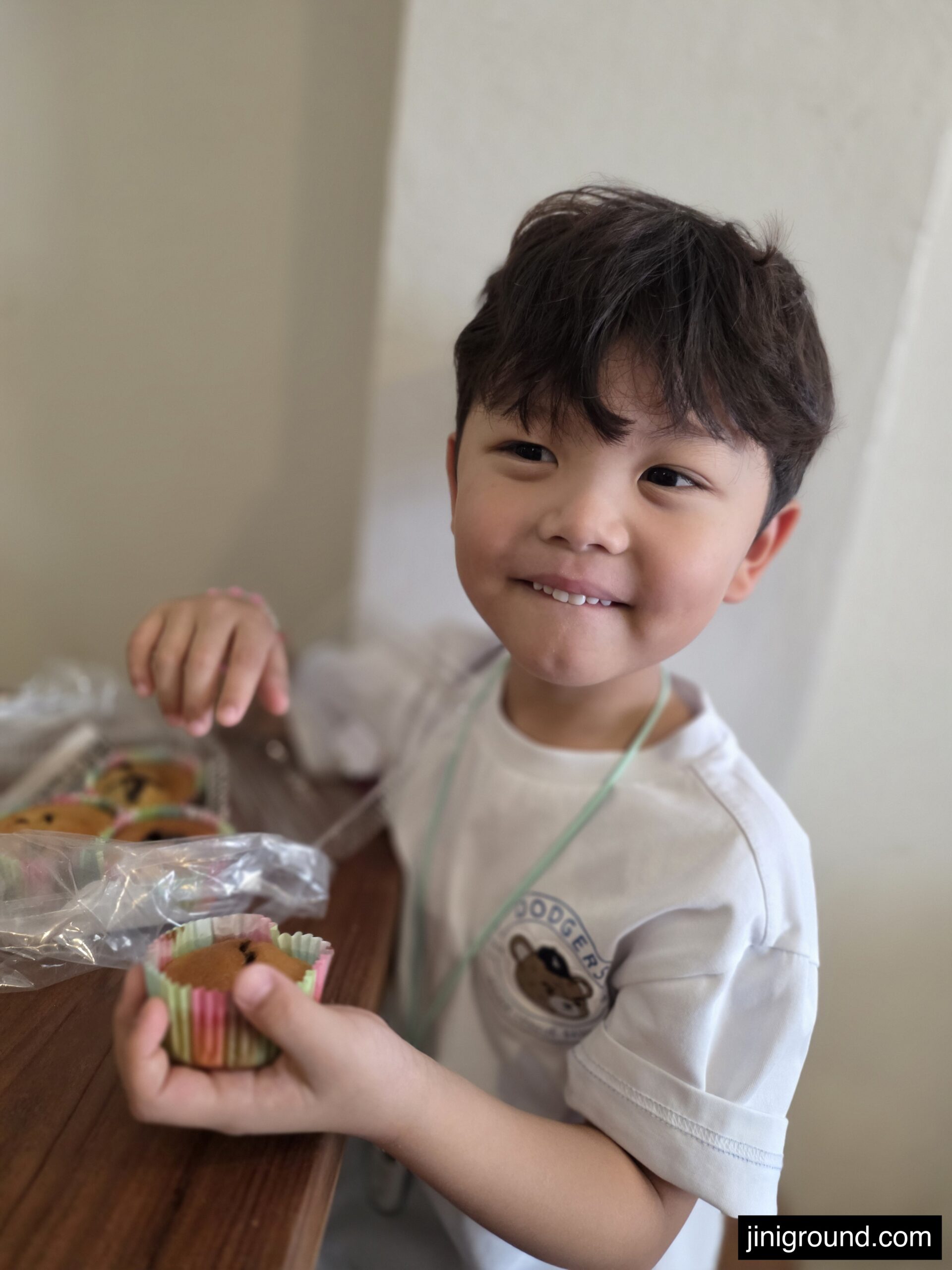 7-year-old Korean boy smiling holding cookie made at ABK Art Studio Chiang Mai
