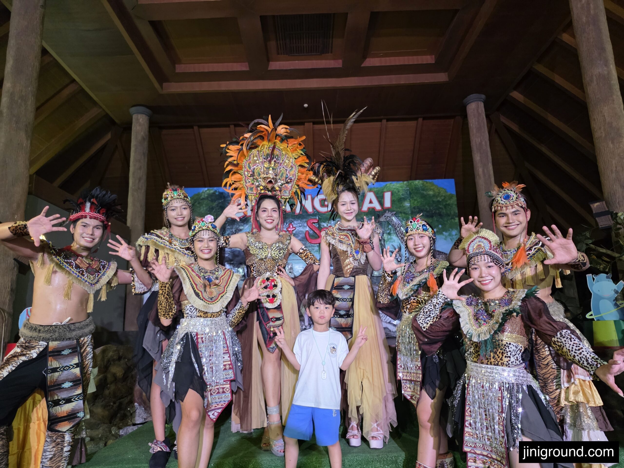 boy posing with night safari performers in traditional costumes at Chiang Mai Night Safari show