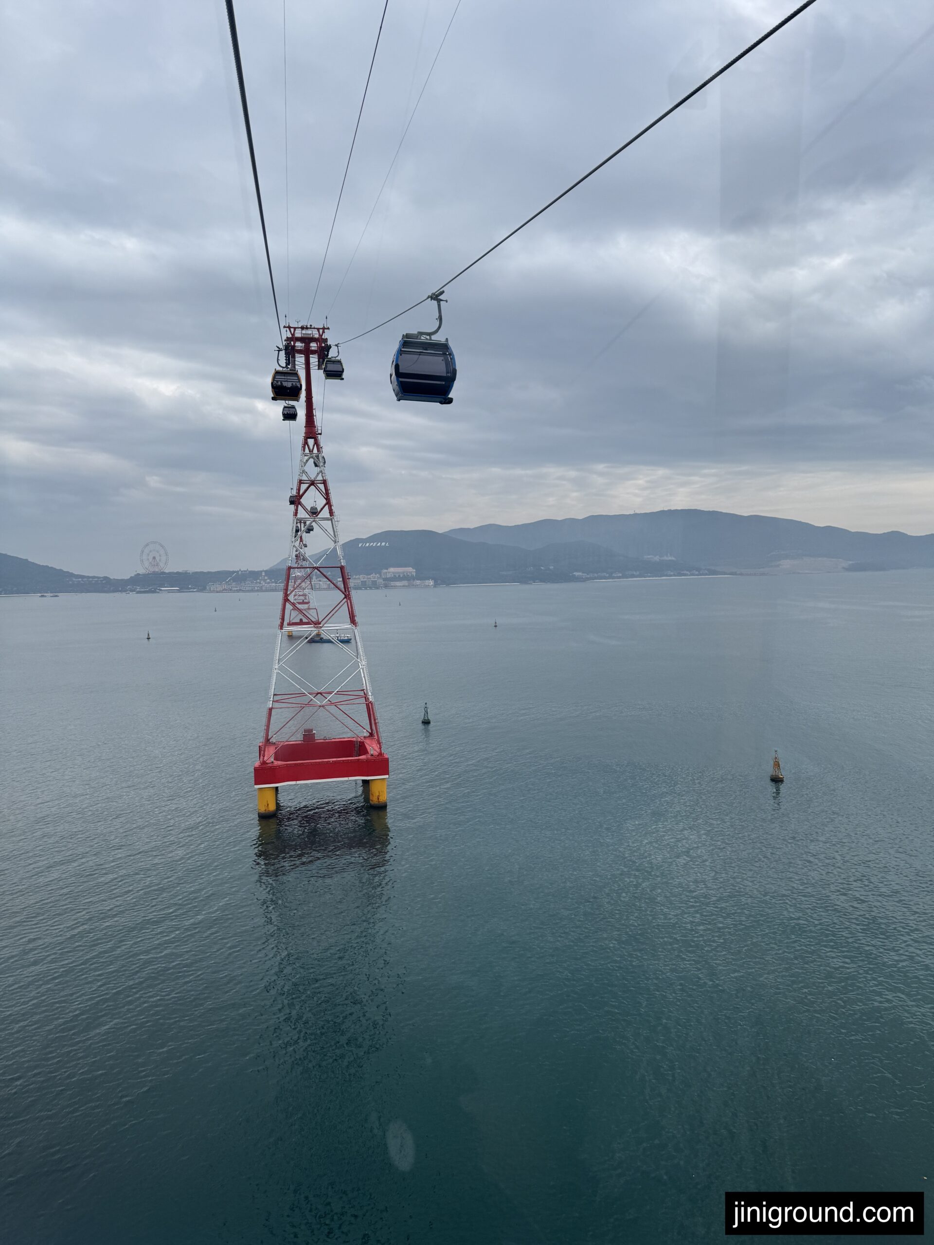 Cable car crossing over turquoise ocean to VinWonders Nha Trang Vietnam with city skyline