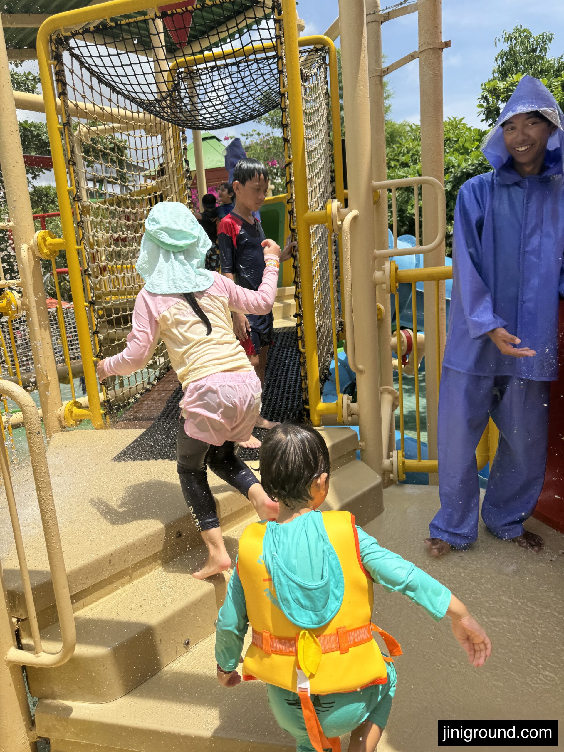 Children wearing safety vests standing on yellow platform at Waterbom Bali
