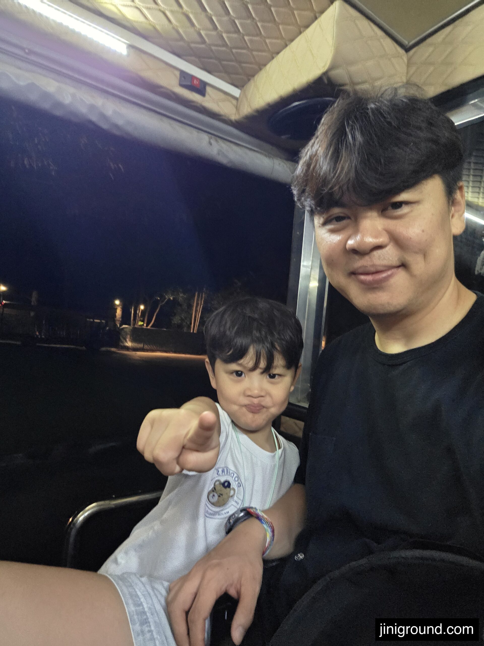dad and son taking selfie on shuttle bus to Chiang Mai Night Safari Thailand
