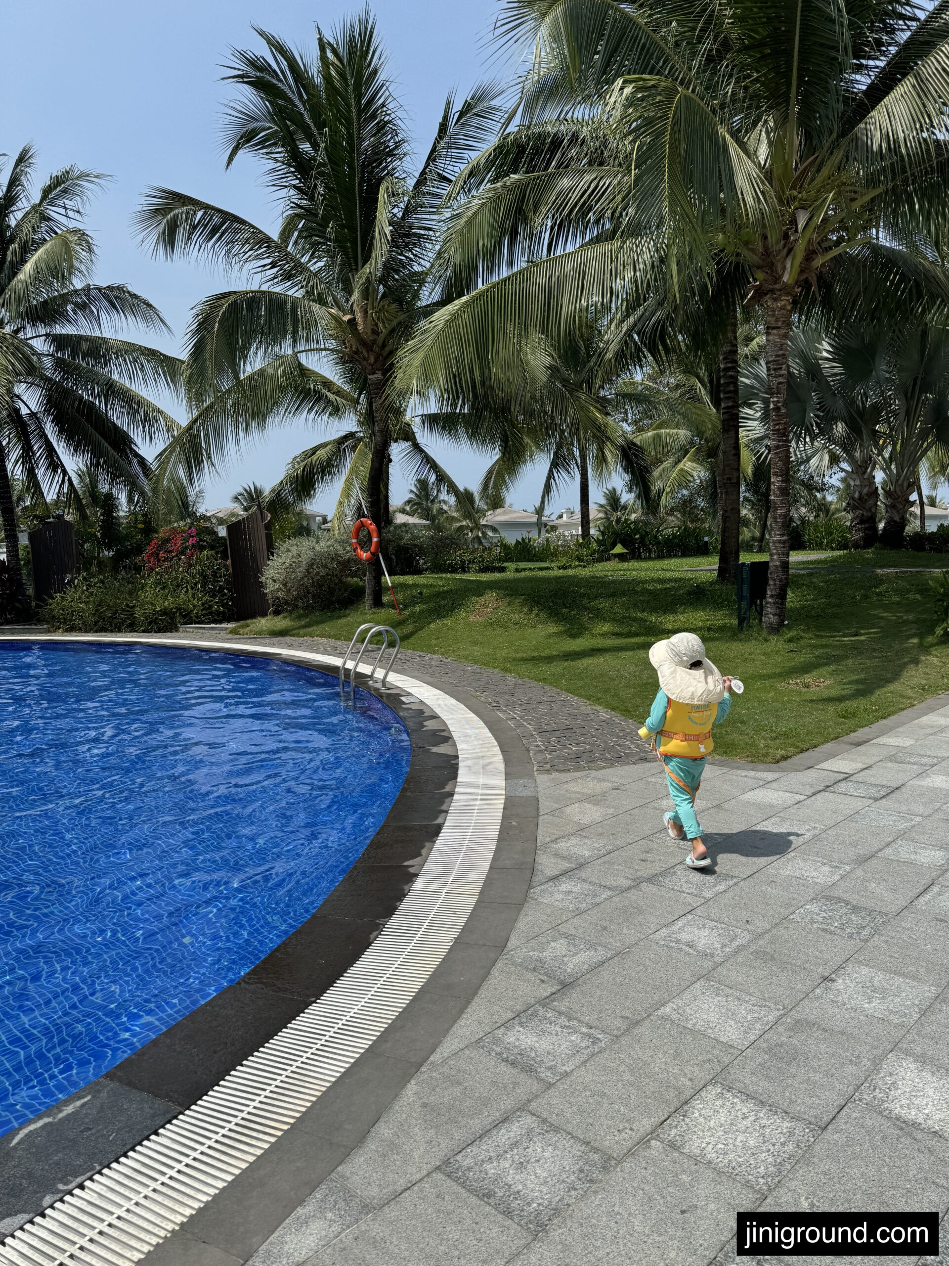 Family on sandy beach during golden sunset at Phu Quoc Vinpearl resort