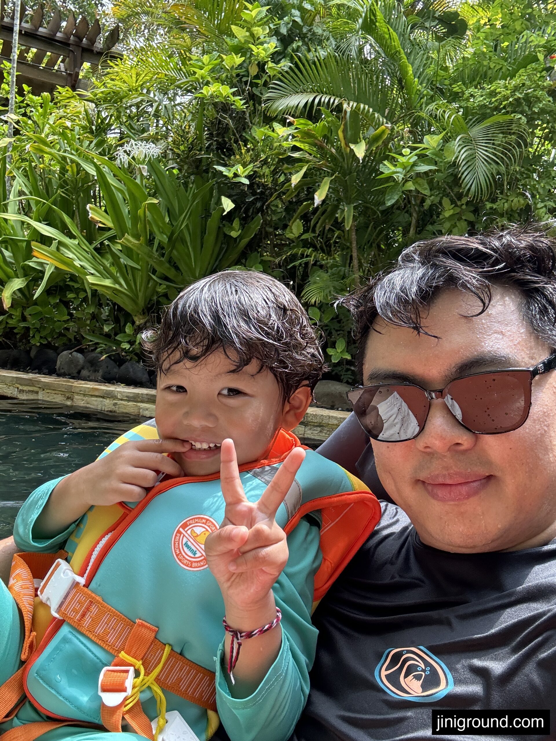 Family wearing sunglasses in tropical Waterbom Bali water park setting