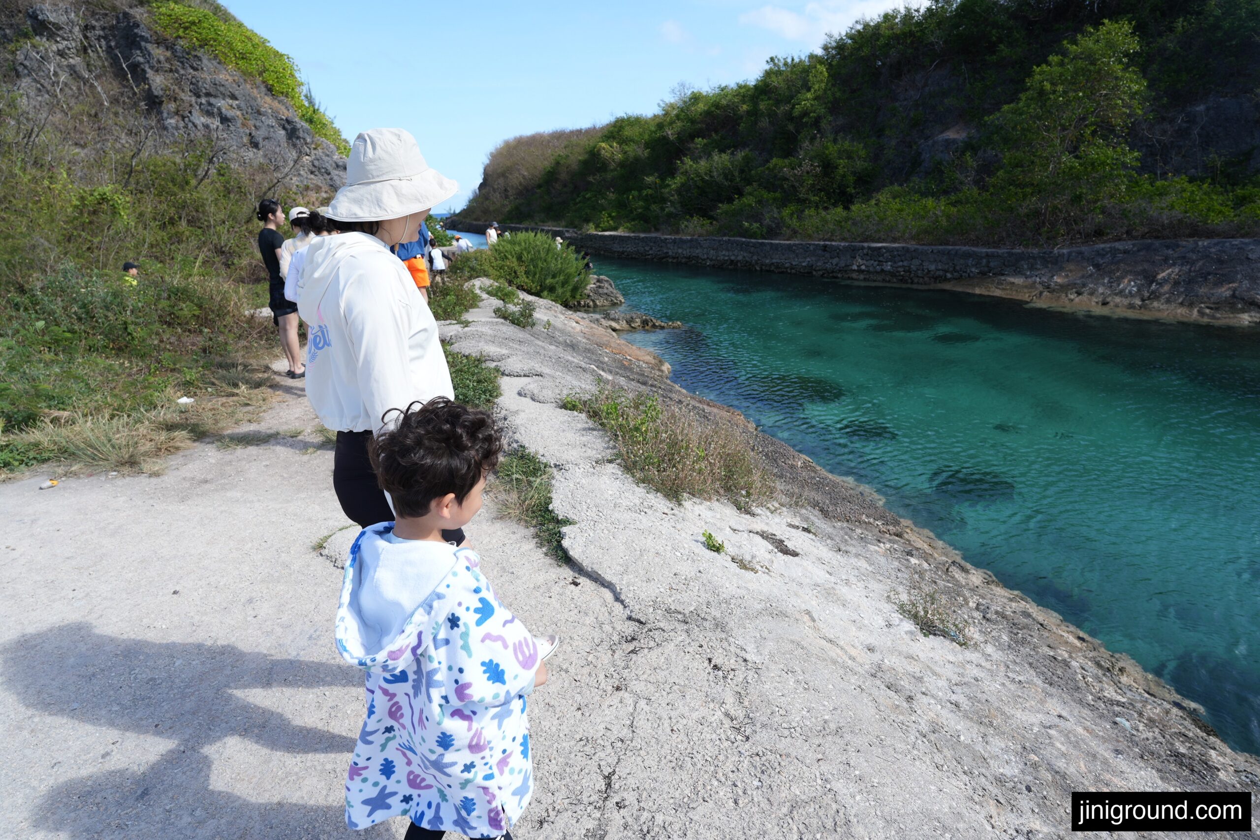 family walking along emerald valley cliff path in Guam with kids