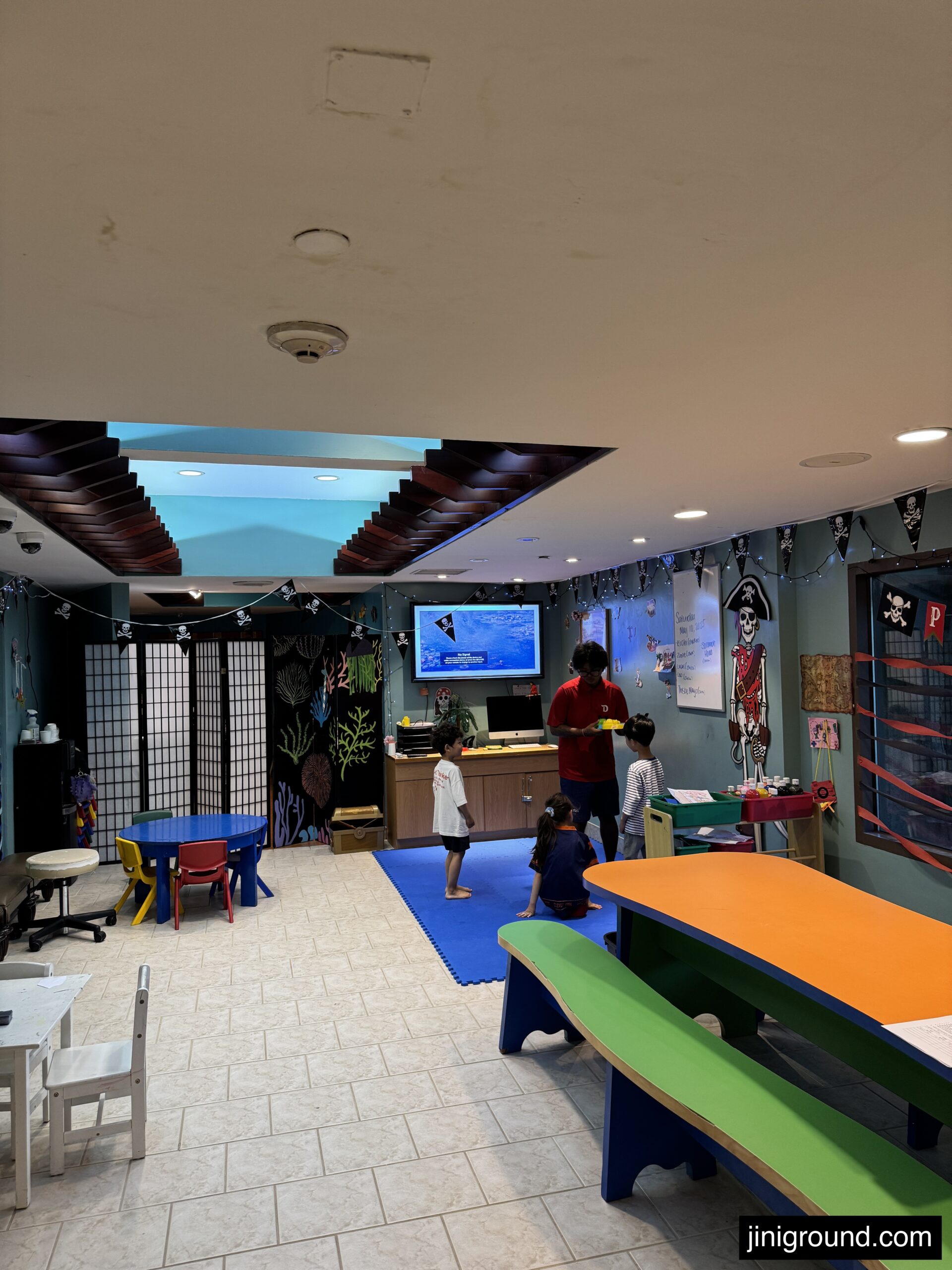 Colorful kids club interior with play area and aquarium at Dusit Beach Resort Guam