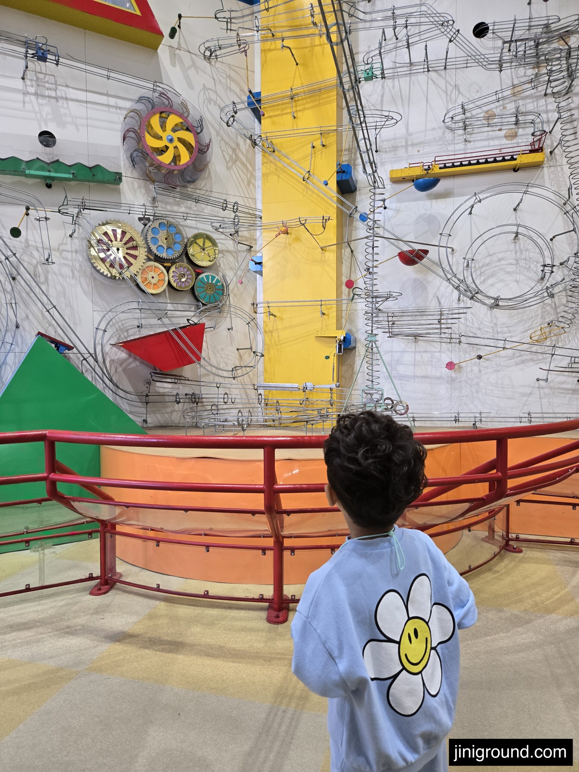 Child engaging with colorful building blocks and floor design display Osaka