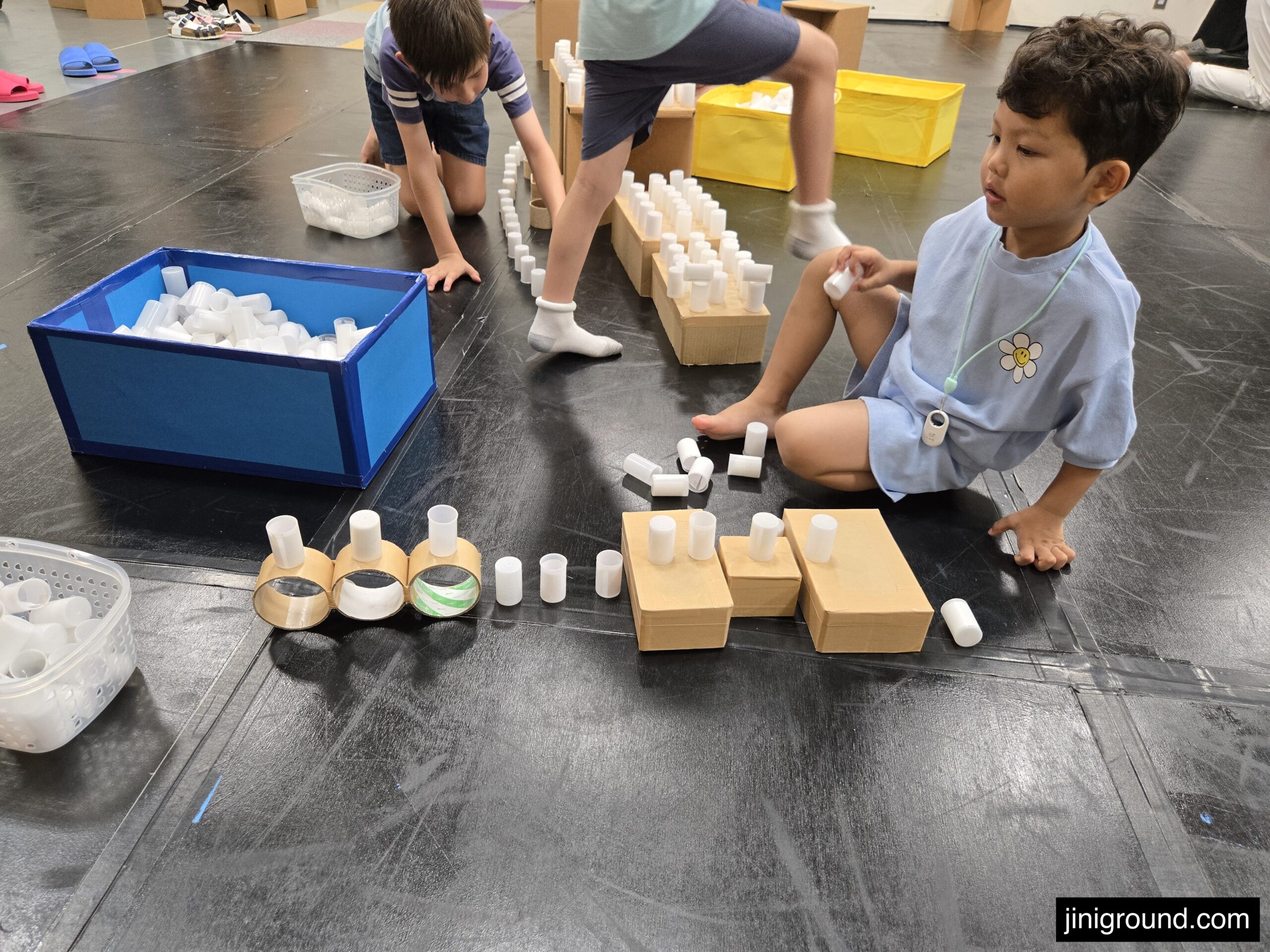 Child participating in craft activity at Osaka Kids Plaza workshop station