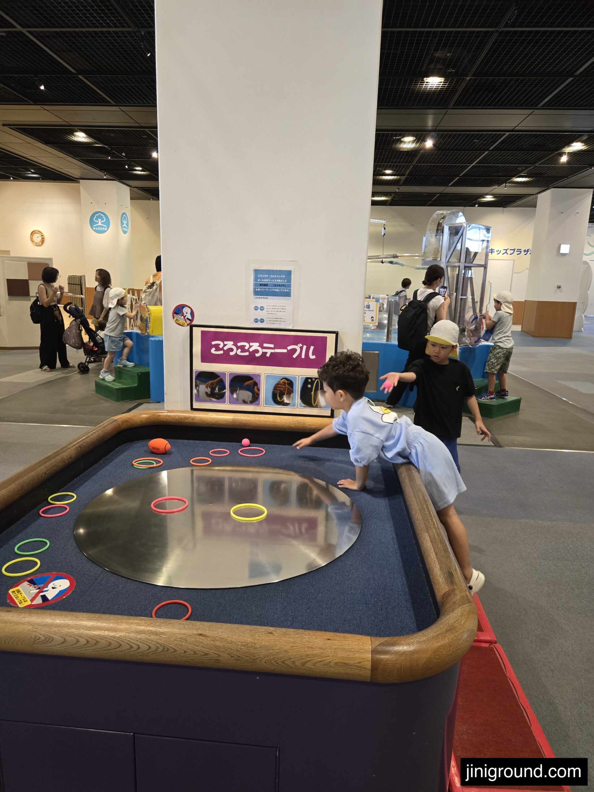 Kids playing interactive digital game exhibit at Osaka Kids Plaza museum
