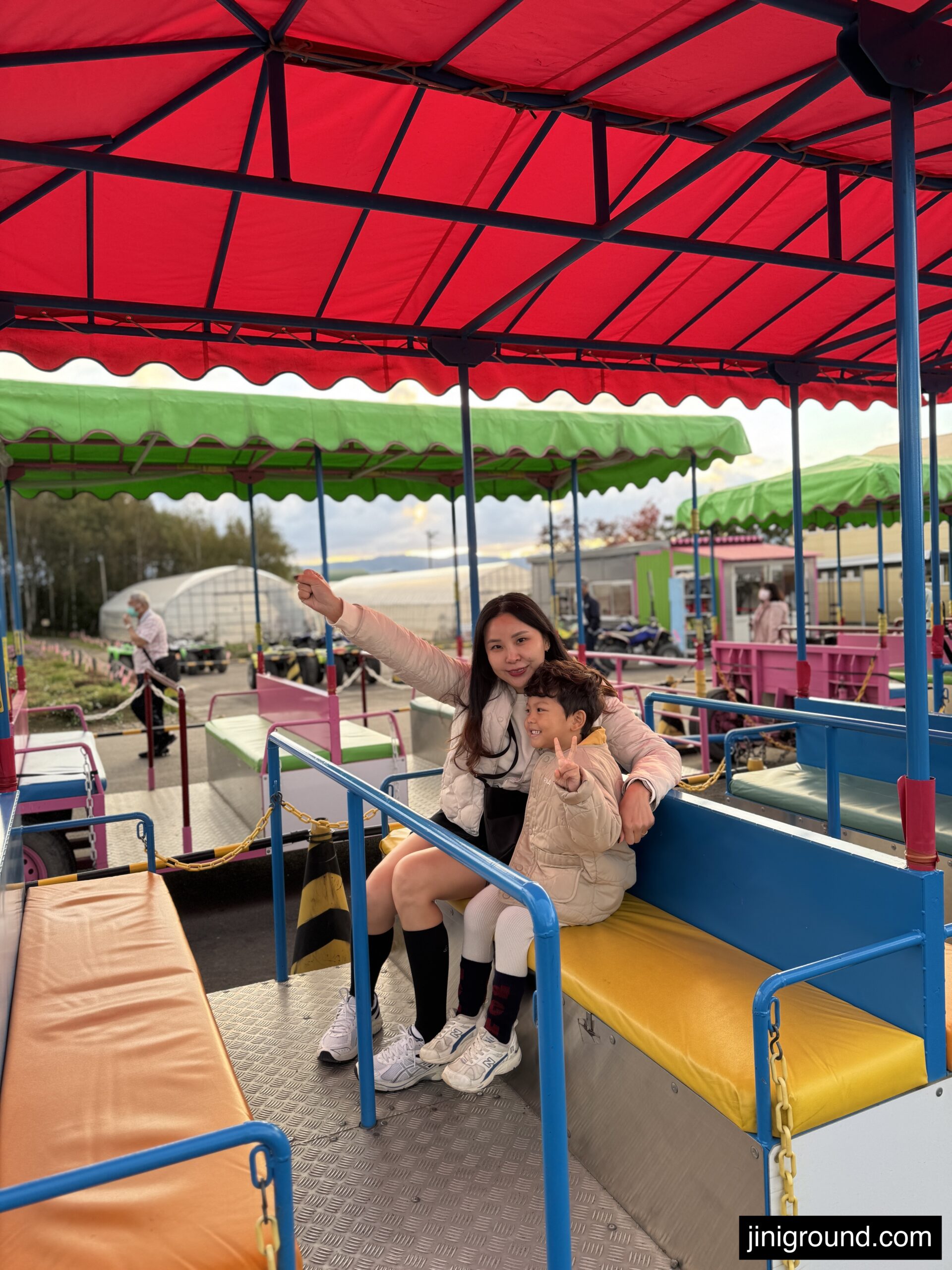 Mom and 53 month old son riding colorful tractor tour at Shikisai no Oka Hill Hokkaido
