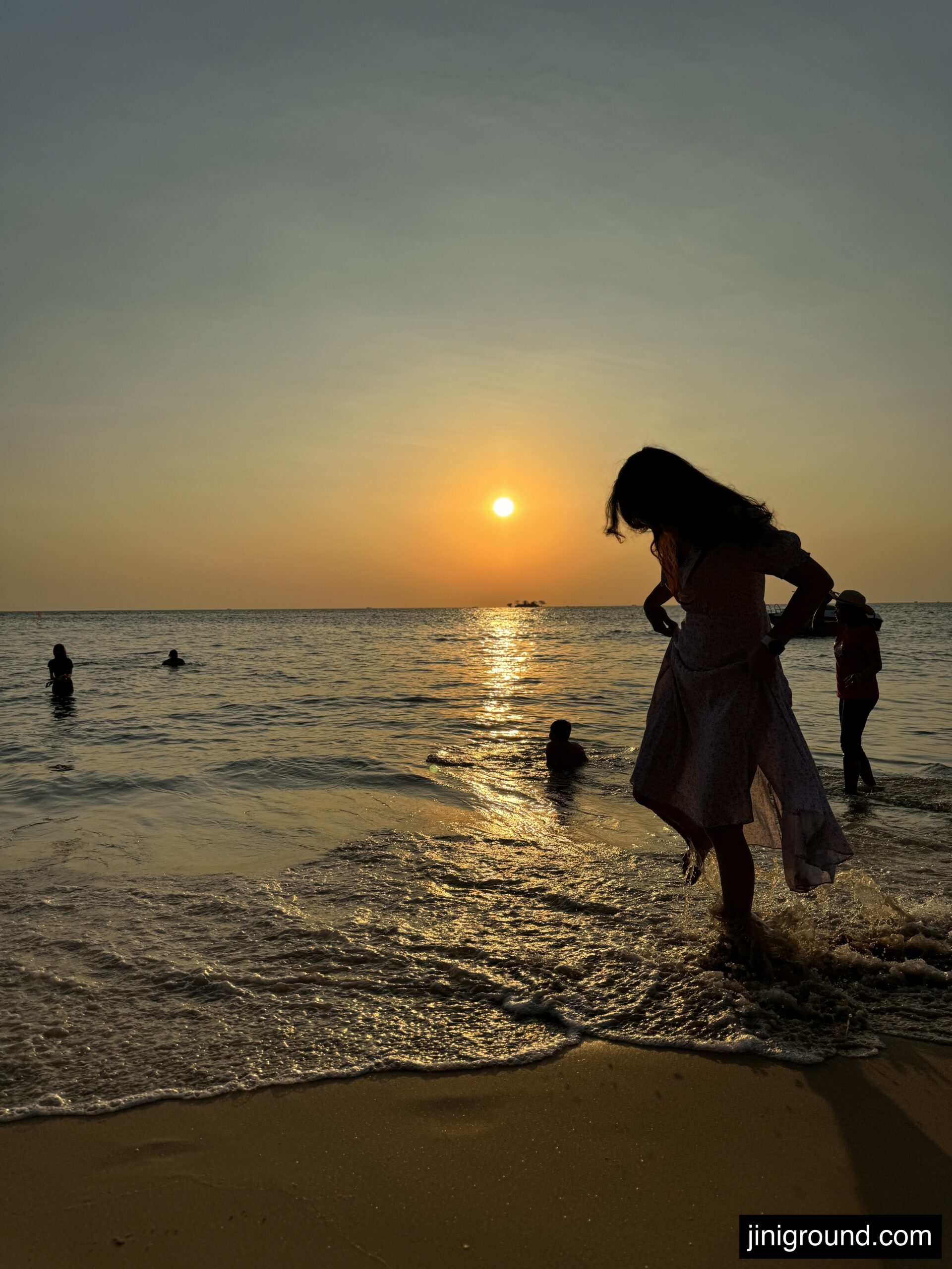 Mother and child walking on beach during beautiful Phu Quoc sunset moment