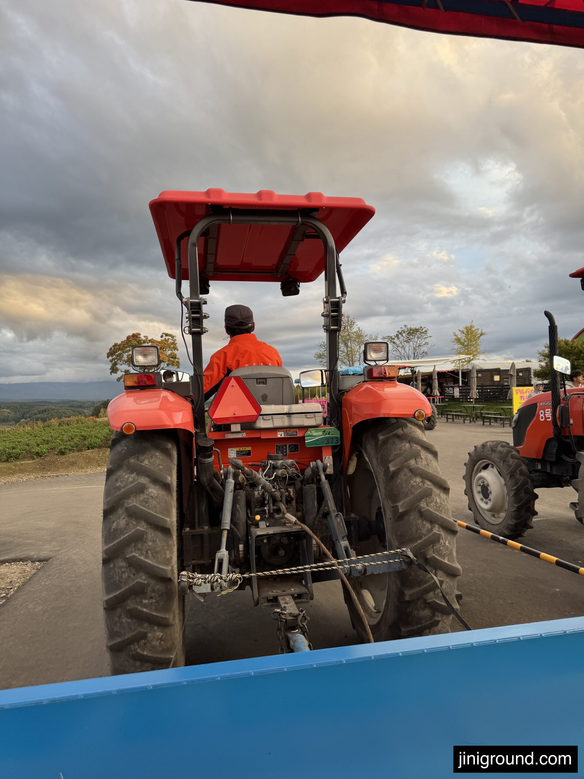 Red farm tractor parked at Shikisai no Oka Hill Biei Hokkaido Japan