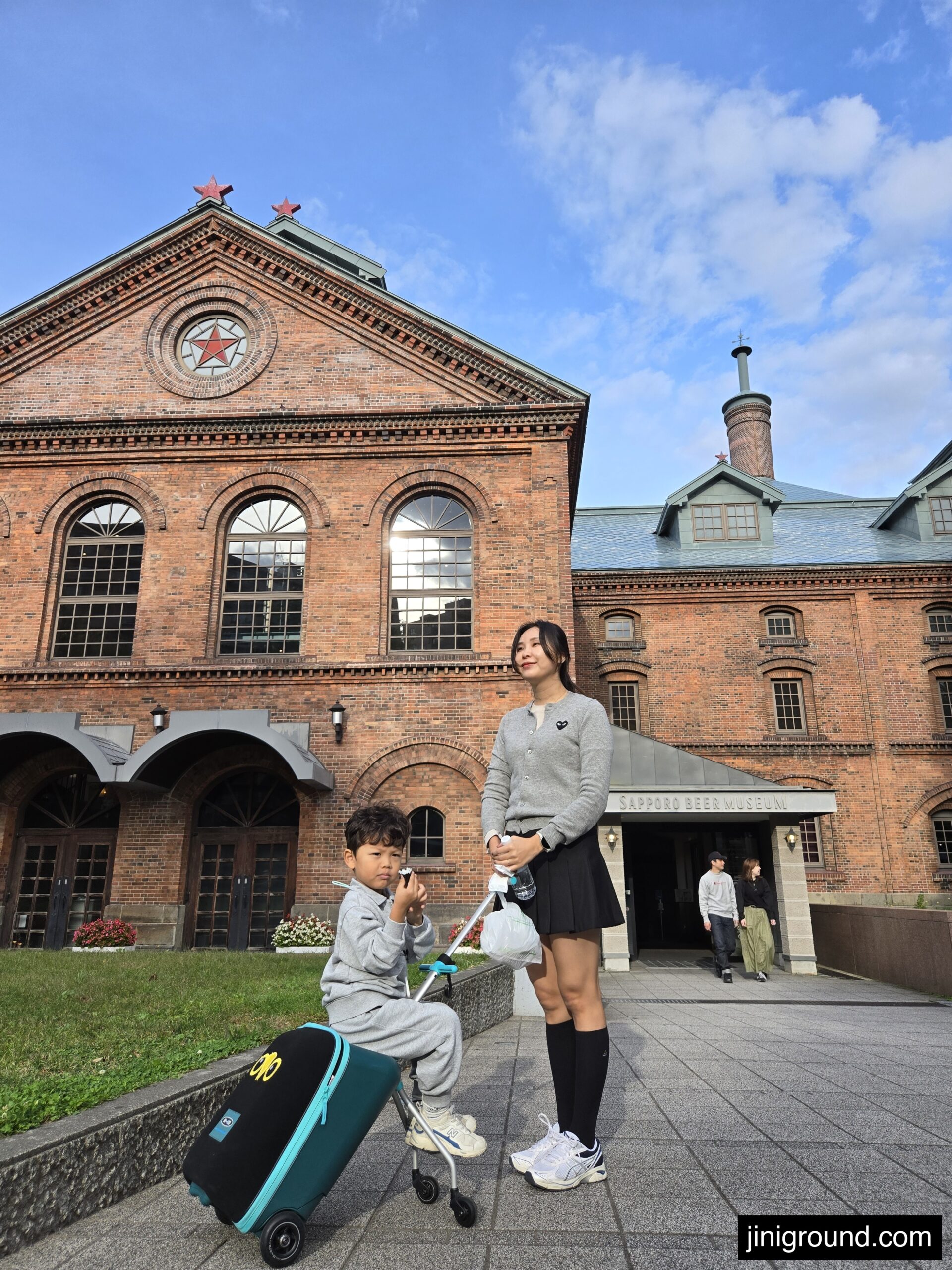 Interactive museum display with illuminated glass case showing Sapporo beer history
