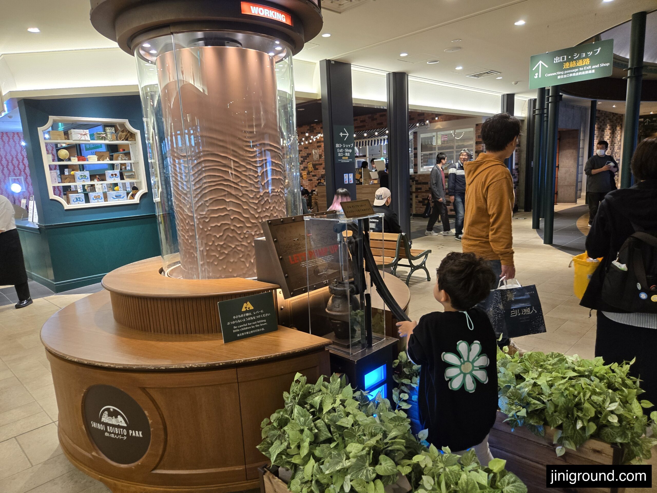 Child holding decorative dessert with character design at Shiroikoibito cafe