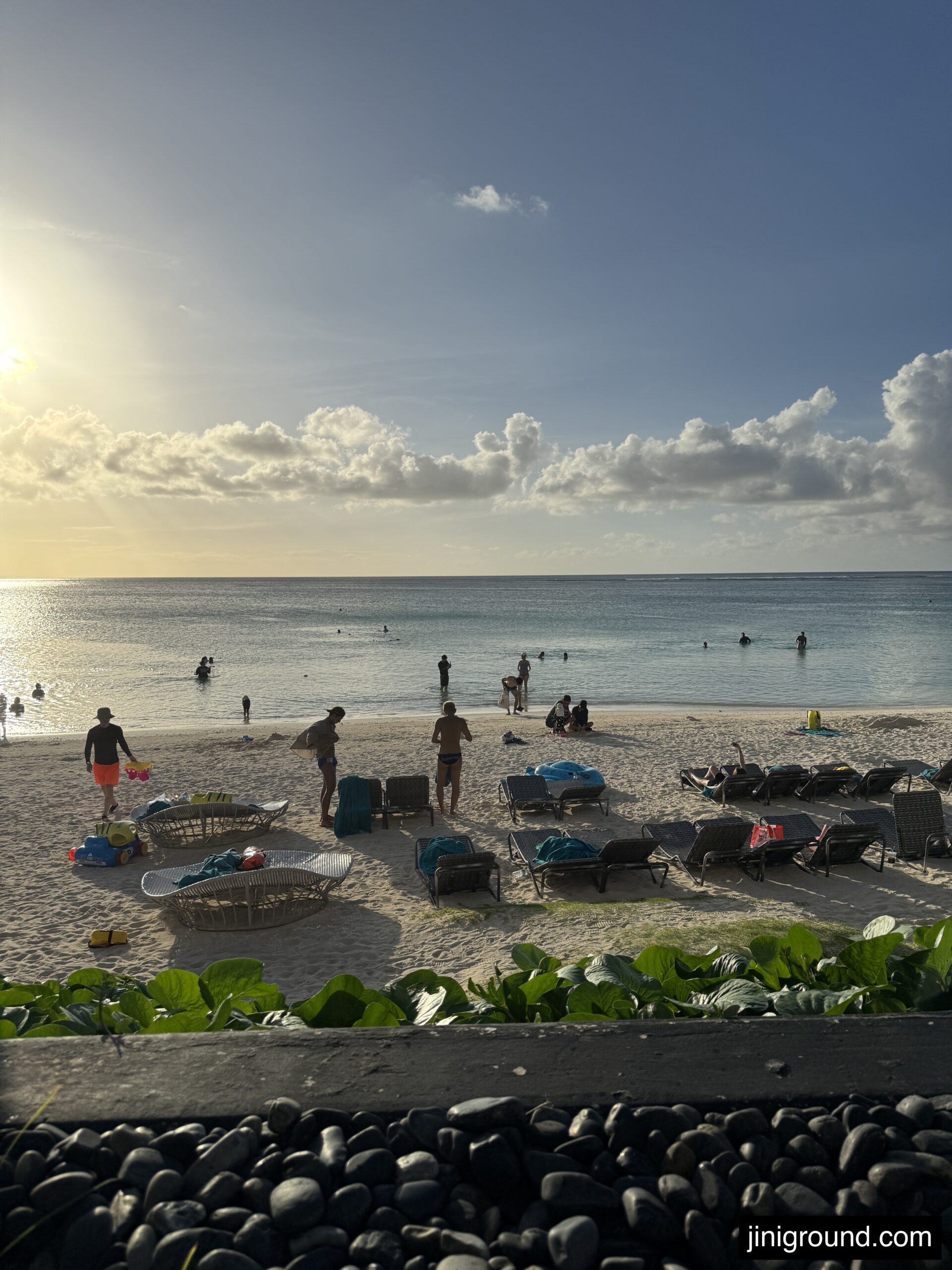 Beautiful sunset view over Tumon Beach with beachgoers from Dusit Beach Resort Guam