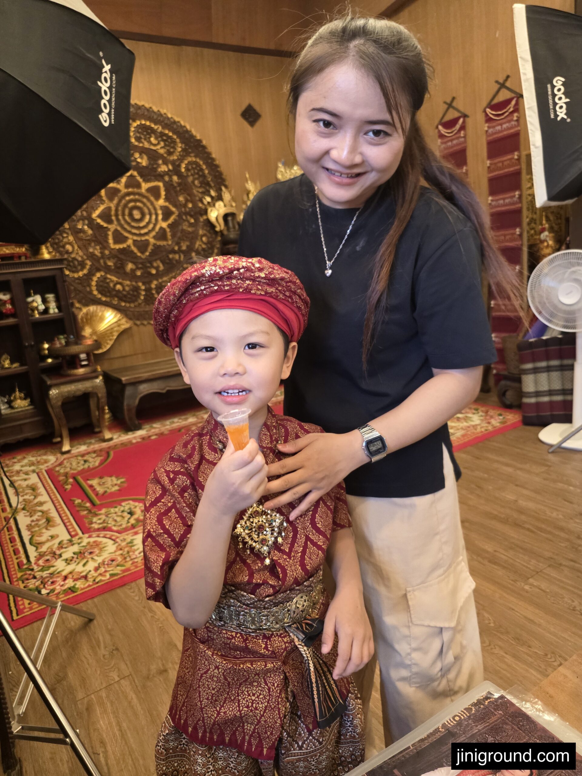 studio staff helping boy put on Thai traditional costume at Nakara Chiangmai Studio