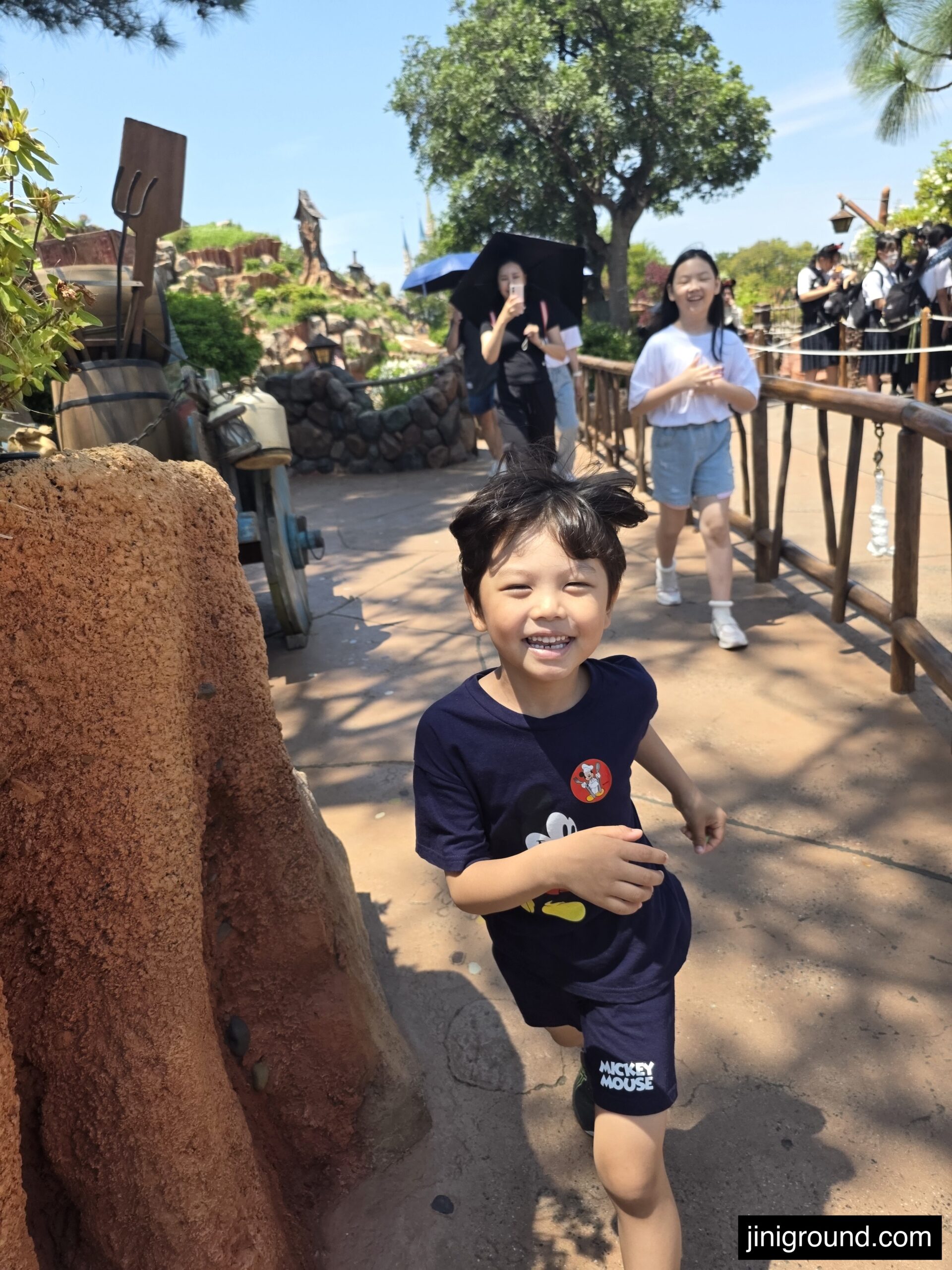 7-year-old boy laughing near Westernland attraction at Tokyo Disneyland