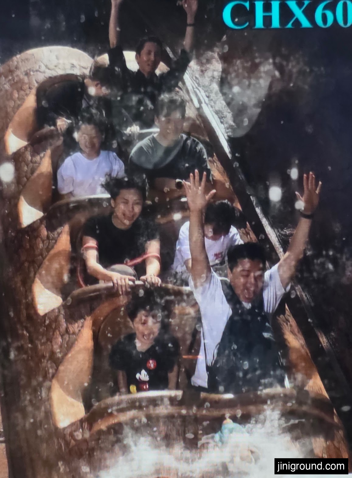 Family riding a splash log flume ride and laughing together at Tokyo Disneyland