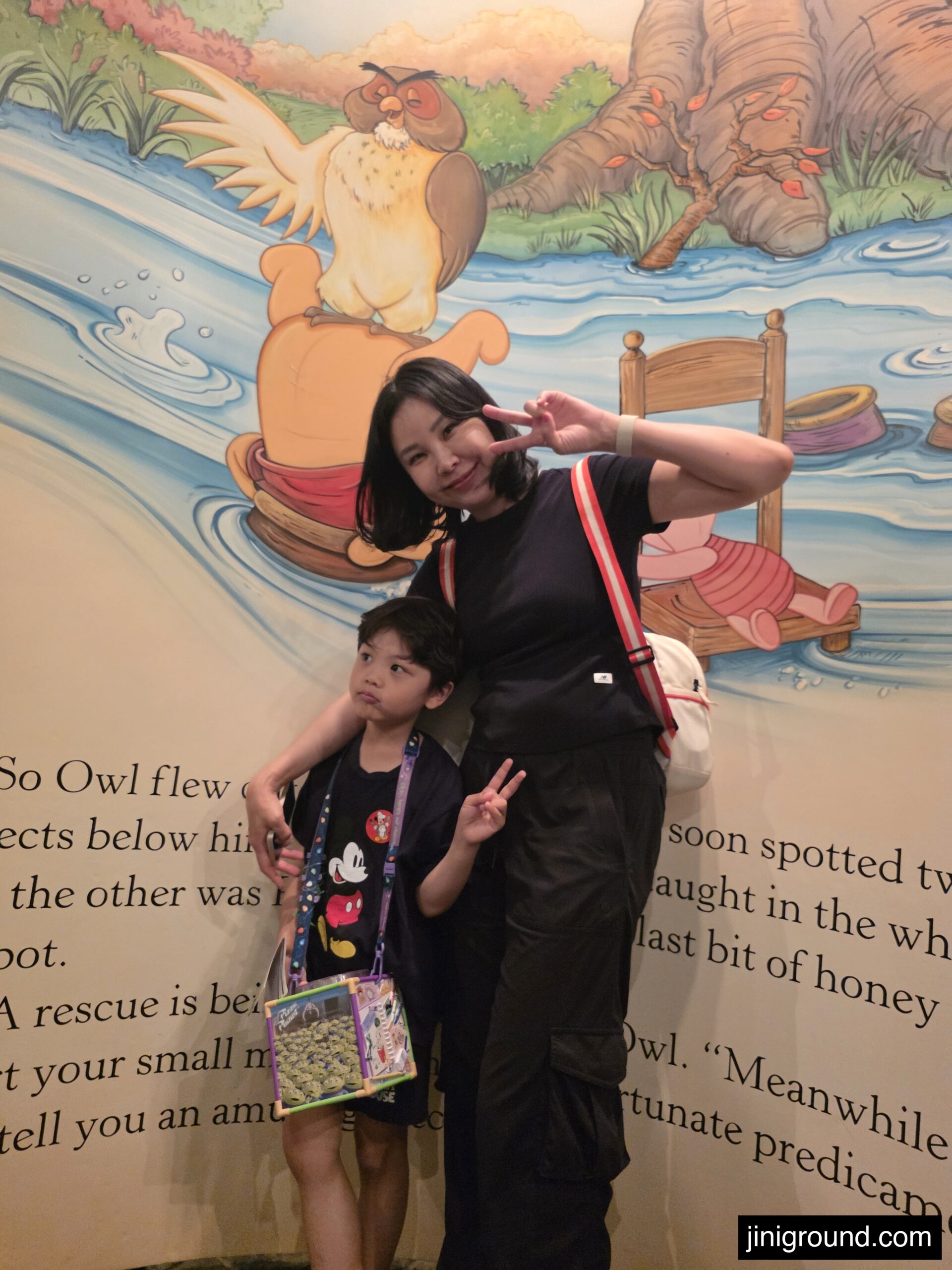 Kids posing at Winnie the Pooh themed photo spot at Tokyo Disneyland