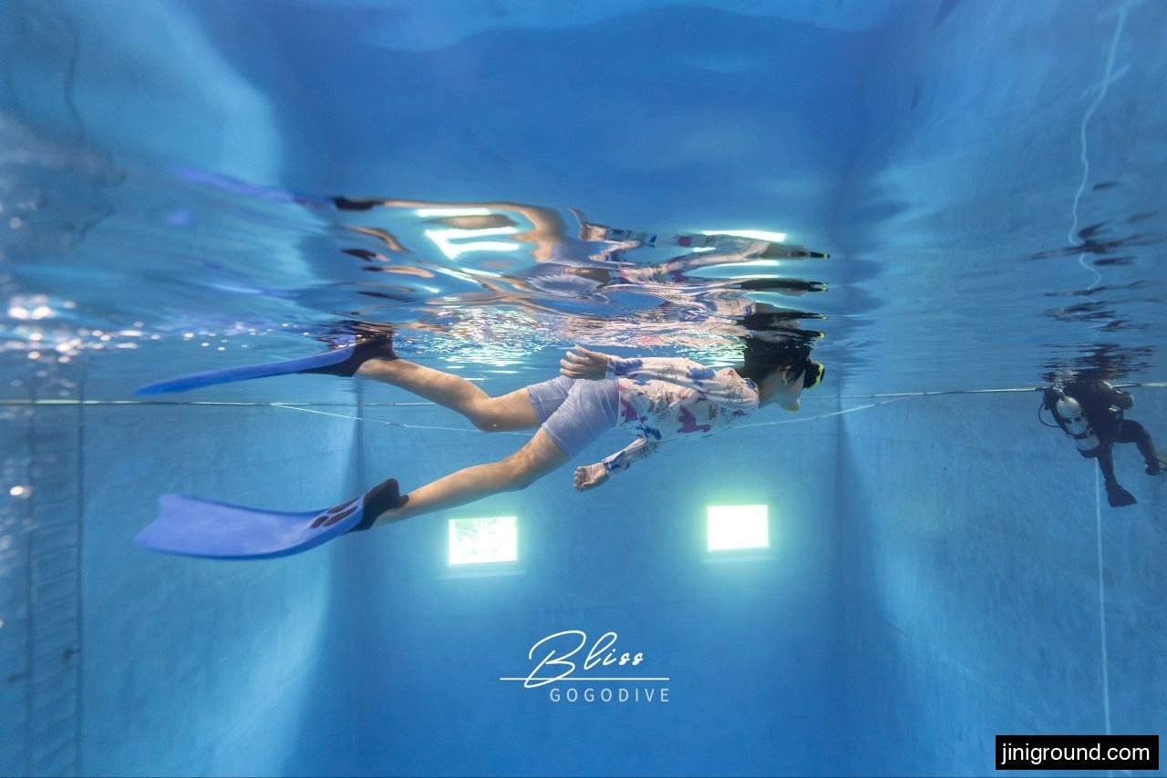 Young boy swimming with fins during kids freediving lesson at Osan diving pool